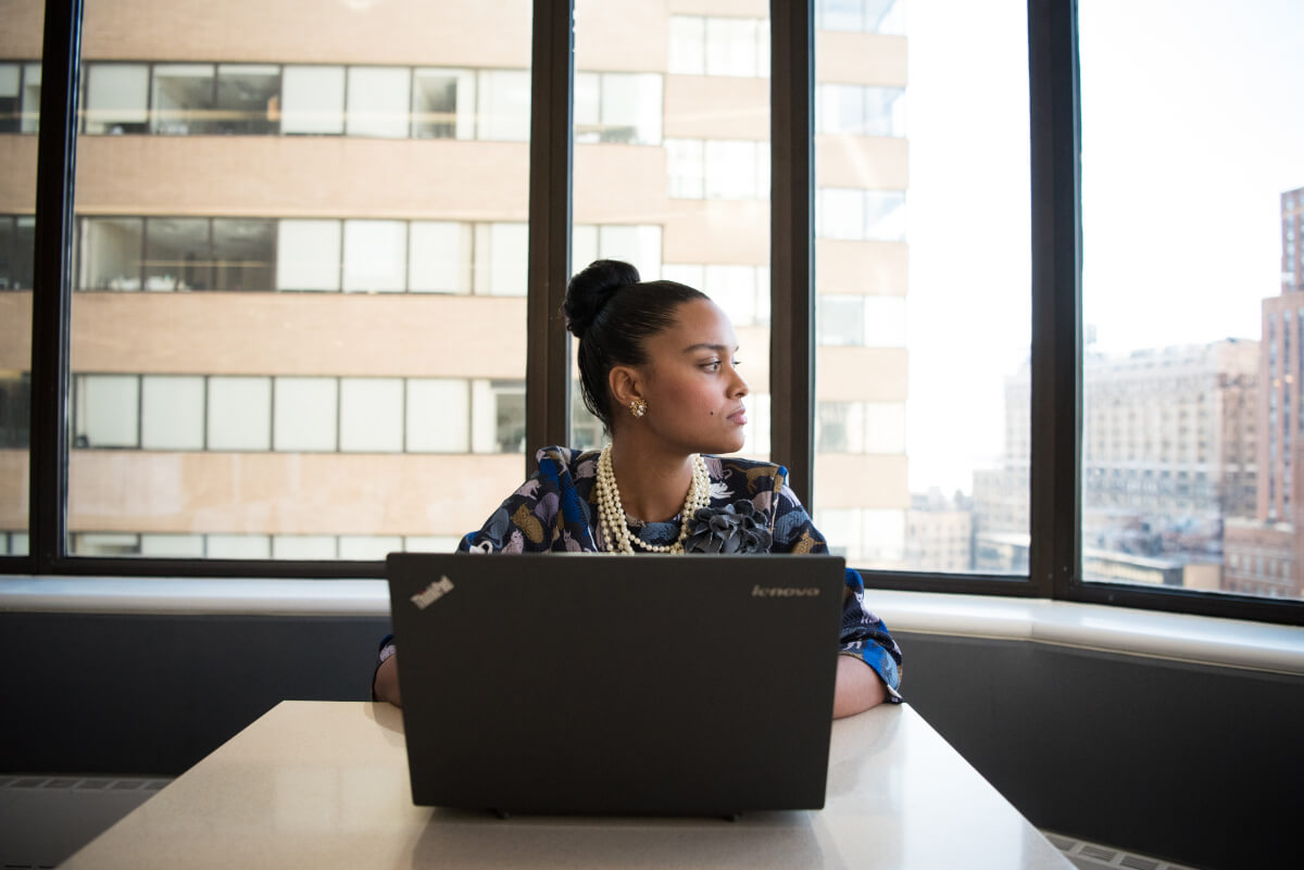 A lady at her workplace looking out of the window